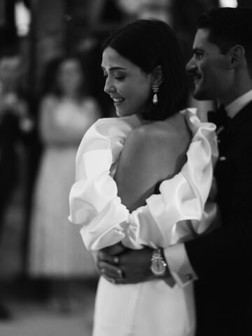 Alejandra & Rubén | Baile de los novios en Galicia Alejandra sonríe mientras baila abrazada a Rubén, en una fotografía en blanco y negro de su boda.